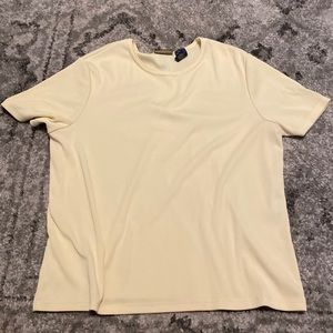 Soft yellow top, 95% Polyester, 5% Spandex.